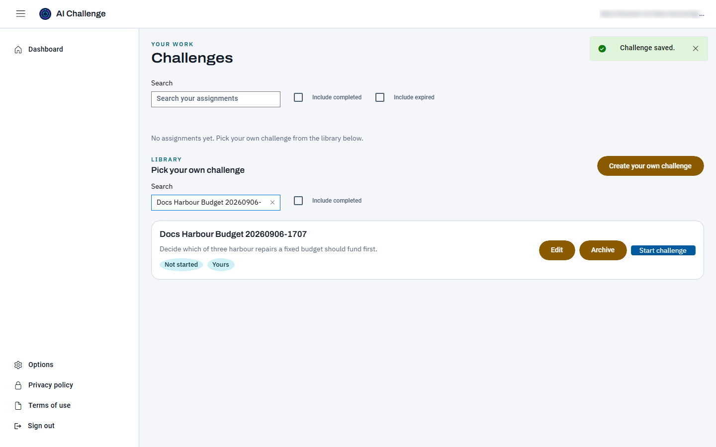 The dashboard just after saving, with a Challenge saved notice at the top right and the library search narrowed to one card carrying the learner's own challenge title and description, a Not started status, a Yours pill, and Edit, Archive and Start challenge buttons.